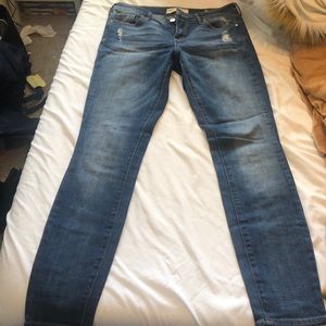 Denim jeans distressed at top and back pockets
